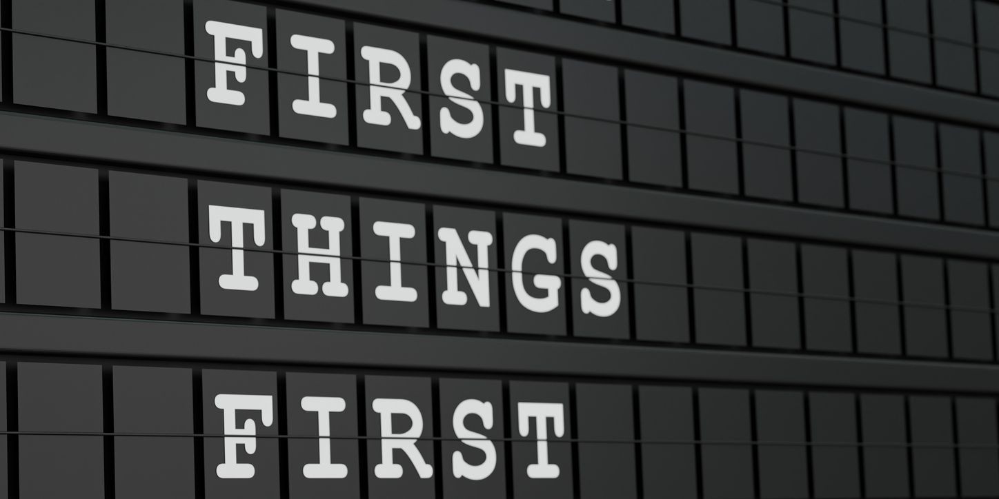 Flipboard display reading 'First Things First' in white letters on a dark background.